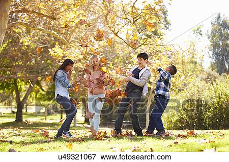 Four Children Throwing Autumn Leaves In The Air View Large Photo Image Stock Photo - Four Children Throwing Autumn Leaves In The Air. Fotosearch