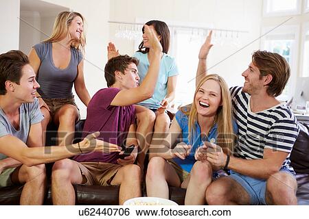 Stock Photograph - Friends Watching Sport Celebrating Goal. Fotosearch
