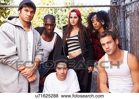 Gang Of Young People In Urban Setting Standing By Fence View Large Photo Image Stock Photo - Gang Of Young People In Urban Setting Standing By Fence. Fotosearch