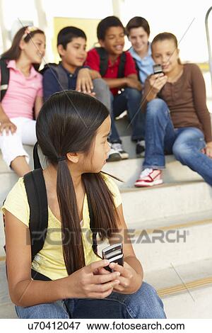 Stock Photo - Girl being bullied in school. Fotosearch