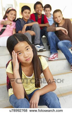 Stock Photo - Girl being bullied in school. Fotosearch