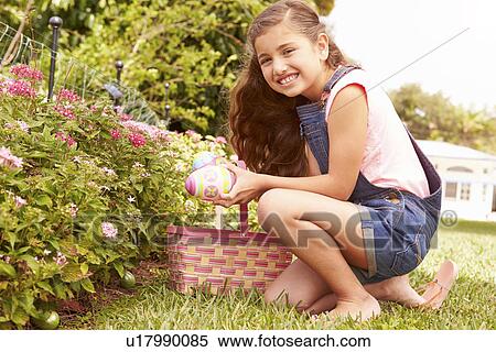 Girl Having Easter Egg Hunt In Garden View Large Photo Image Stock Photography - Girl Having Easter Egg Hunt In Garden. Fotosearch