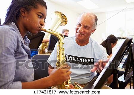 Girl Learning To Play Saxophone In High School Orchestra View Large Photo Image Stock Photo - Girl Learning To Play Saxophone In High School Orchestra. Fotosearch