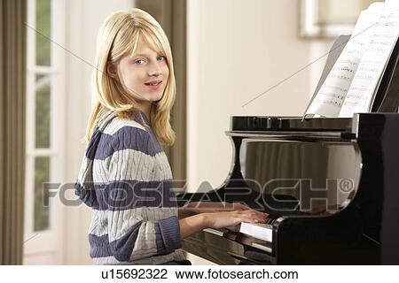 Girl playing grand piano at home View Large Photo Image Stock Image - Girl playing grand piano at home. Fotosearch