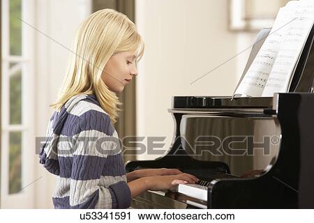 Girl playing grand piano at home View Large Photo Image Stock Image - Girl playing grand piano at home. Fotosearch