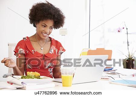 Stock Photograph - Girl Pretending To Be Businesswoman Working At Desk. Fotosearch
