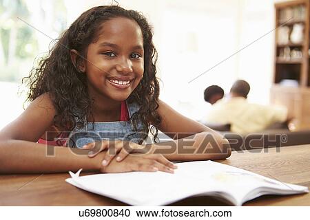 Girl Reading Book For Homework At Table View Large Photo Image Stock Image - Girl Reading Book For Homework At Table. Fotosearch