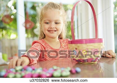 Girl With Chocolate Easter Eggs And Basket At Home View Large Photo Image Stock Photograph - Girl With Chocolate Easter Eggs And Basket At Home. Fotosearch