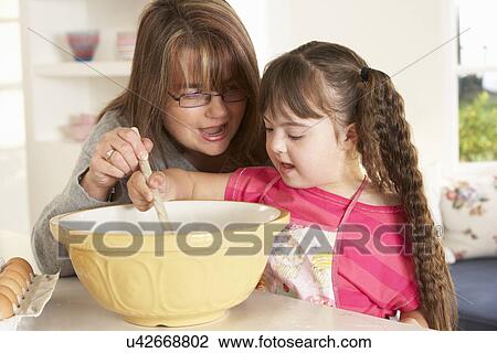 Girl with Downs Syndrome baking with mother View Large Photo Image Stock Image - Girl with Downs Syndrome baking with mother. Fotosearch