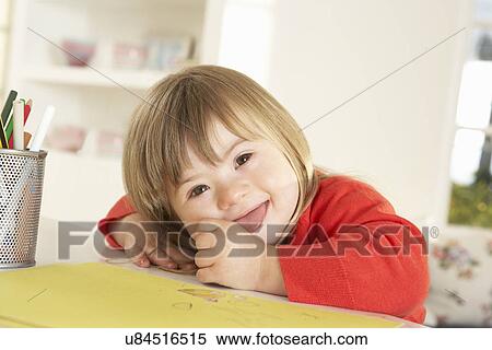 Girl with Downs Syndrome drawing View Large Photo Image Stock Photography - Girl with Downs Syndrome drawing. Fotosearch
