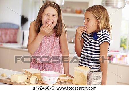 Girls Eating Ingredients Whilst Making Cheese On Toast View Large Photo Image Stock Image - Girls Eating Ingredients Whilst Making Cheese On Toast. Fotosearch