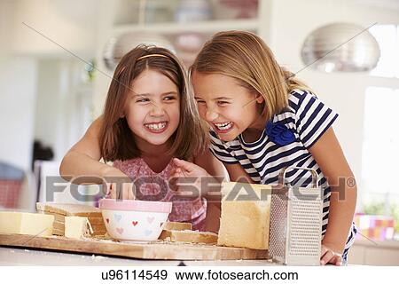 Girls Eating Ingredients Whilst Making Cheese On Toast View Large Photo Image Stock Photo - Girls Eating Ingredients Whilst Making Cheese On Toast. Fotosearch