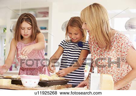Girls With Mother Making Cheese On Toast View Large Photo Image Stock Photo - Girls With Mother Making Cheese On Toast. Fotosearch