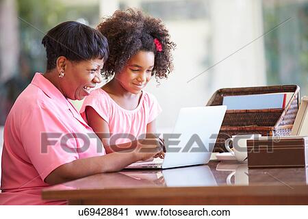 Granddaughter Helping Grandmother With Laptop View Large Photo Image Stock Image - Granddaughter Helping Grandmother With Laptop. Fotosearch