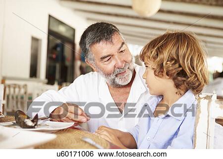 Grandfather And Grandson Enjoying Meal In Restaurant View Large Photo Image Stock Photograph - Grandfather And Grandson Enjoying Meal In Restaurant. Fotosearch