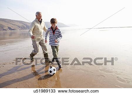 Grandfather And Grandson Playing Football On Winter Beach View Large Photo Image Stock Image - Grandfather And Grandson Playing Football On Winter Beach. Fotosearch