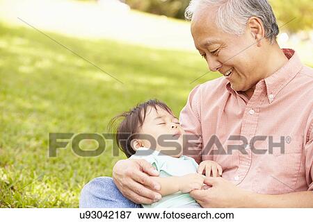 Grandfather Holding Sleeping Grandson In Park View Large Photo Image Stock Photo - Grandfather Holding Sleeping Grandson In Park. Fotosearch