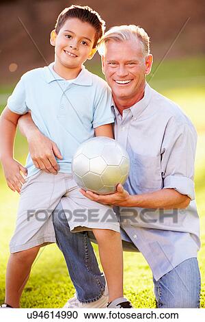 Grandfather Playing Football With Grandson In Park View Large Photo Image Stock Image - Grandfather Playing Football With Grandson In Park. Fotosearch