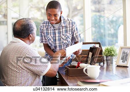 Grandfather Showing Document To Grandson View Large Photo Image Picture - Grandfather Showing Document To Grandson. Fotosearch