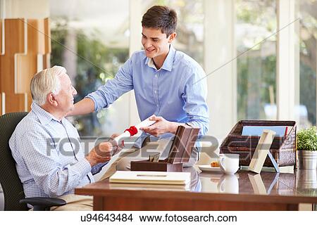 Grandfather Showing Document To Teenage Grandson View Large Photo Image Picture - Grandfather Showing Document To Teenage Grandson. Fotosearch