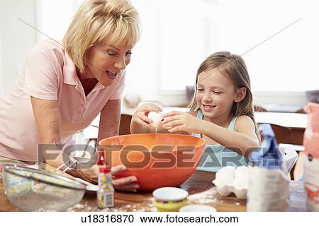 Grandmother And Granddaughter Baking Together At Home View Large Photo Image Stock Image - Grandmother And Granddaughter Baking Together At Home. Fotosearch