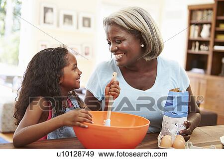 Grandmother And Granddaughter Baking Together At Home View Large Photo Image Stock Photo - Grandmother And Granddaughter Baking Together At Home. Fotosearch