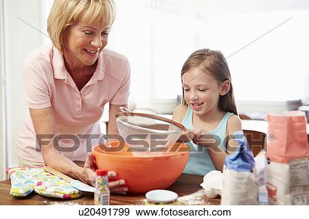 Grandmother And Granddaughter Baking Together At Home View Large Photo Image Stock Photo - Grandmother And Granddaughter Baking Together At Home. Fotosearch
