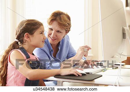 Grandmother And Granddaughter Using Computer At Home View Large Photo Image Stock Photo - Grandmother And Granddaughter Using Computer At Home. Fotosearch