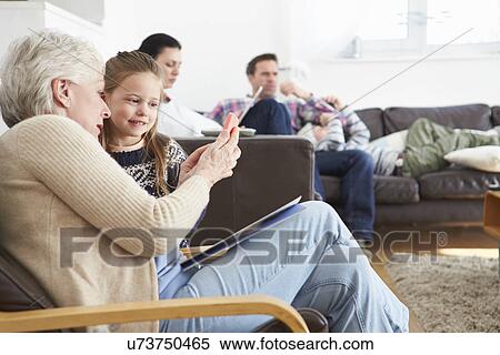 Grandmother And Granddaughter Using Mobile Phone Together View Large Photo Image Stock Photography - Grandmother And Granddaughter Using Mobile Phone Together. Fotosearch