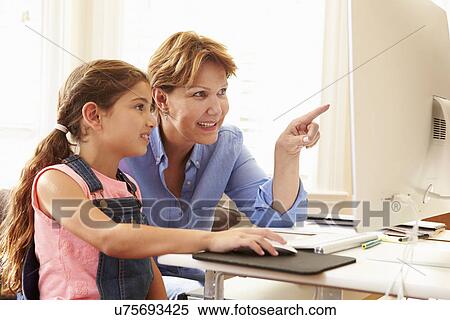 Grandmother And Granddaughter Using Computer At Home View Large Photo Image Stock Photography - Grandmother And Granddaughter Using Computer At Home. Fotosearch