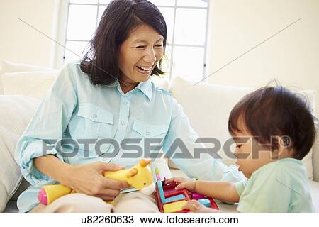 Grandmother And Grandson Playing With Toy Together View Large Photo Image Stock Image - Grandmother And Grandson Playing With Toy Together. Fotosearch