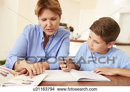 Grandmother Helping Grandson With Homework View Large Photo Image Picture - Grandmother Helping Grandson With Homework . Fotosearch