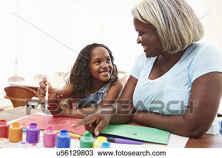 Grandmother Painting Picture With Granddaughter At Home View Large Photo Image Stock Image - Grandmother Painting Picture With Granddaughter At Home. Fotosearch