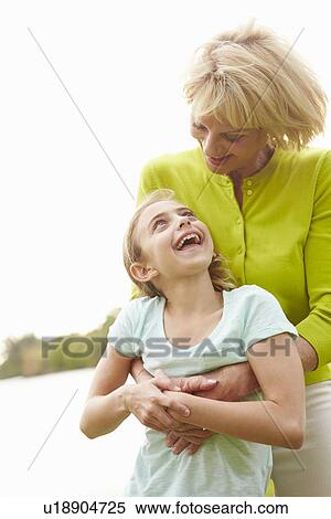Stock Photography - Grandmother Playing With Granddaughter Outdoors. Fotosearch