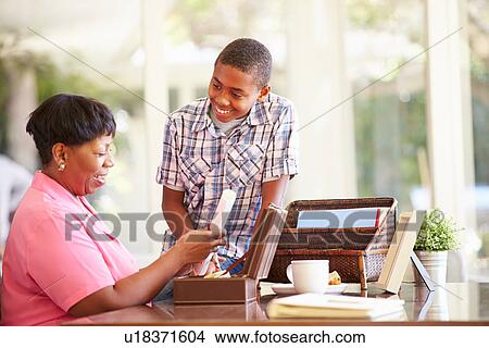 Grandmother Showing Document To Grandson View Large Photo Image Picture - Grandmother Showing Document To Grandson. Fotosearch
