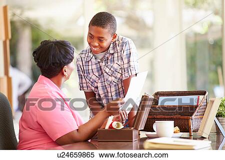 Grandmother Showing Document To Grandson View Large Photo Image Stock Photography - Grandmother Showing Document To Grandson. Fotosearch