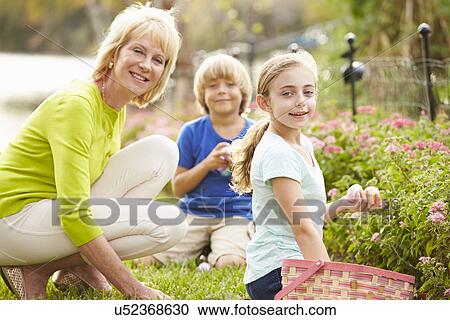 Grandmother With Grandchildren On Easter Egg Hunt In Garden View Large Photo Image Stock Image - Grandmother With Grandchildren On Easter Egg Hunt In Garden. Fotosearch