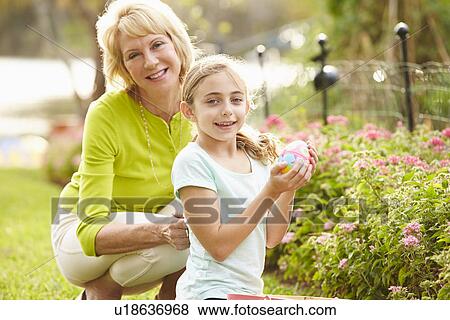 Grandmother With Granddaughter On Easter Egg Hunt In Garden View Large Photo Image Stock Photo - Grandmother With Granddaughter On Easter Egg Hunt In Garden. Fotosearch