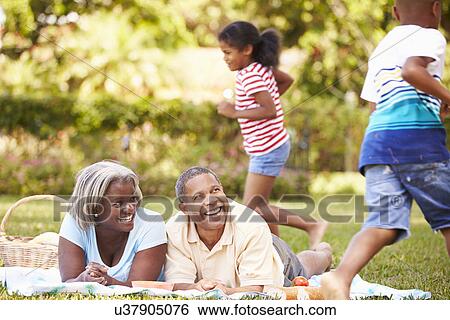 Grandparents And Grandchildren Having Picnic In Garden View Large Photo Image Stock Photograph - Grandparents And Grandchildren Having Picnic In Garden . Fotosearch