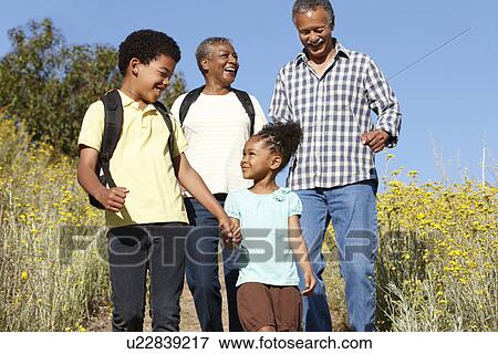 Stock Photo - Grandparents and grandchildren on country hike. Fotosearch