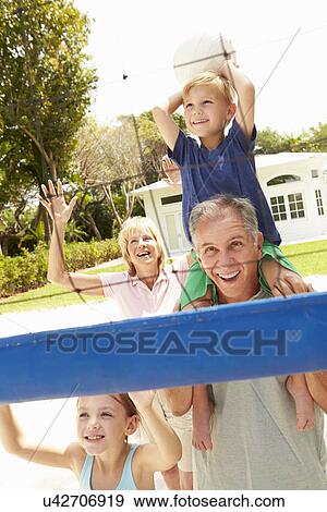 Grandparents And Grandchildren Playing Volleyball Together View Large Photo Image Stock Photo - Grandparents And Grandchildren Playing Volleyball Together. Fotosearch