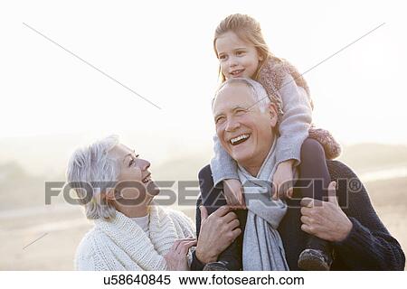 Grandparents And Granddaughter Walking On Winter Beach View Large Photo Image Stock Photography - Grandparents And Granddaughter Walking On Winter Beach. Fotosearch