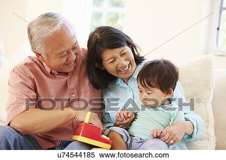 Stock Photography - Grandparents And Grandson Playing With Toy Together. Fotosearch