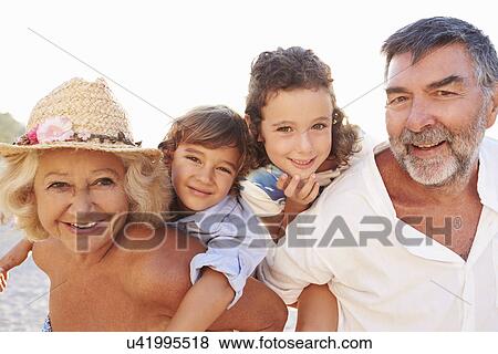 Grandparents Giving Grandchildren Piggybacks On Summer Holiday View Large Photo Image Stock Photo - Grandparents Giving Grandchildren Piggybacks On Summer Holiday. Fotosearch