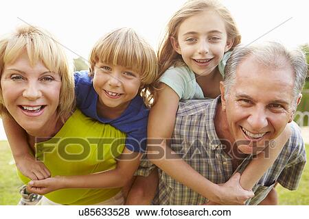 Grandparents Giving Grandchildren Piggyback Ride In Garden View Large Photo Image Stock Photo - Grandparents Giving Grandchildren Piggyback Ride In Garden . Fotosearch