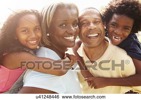 Grandparents Giving Grandchildren Piggyback Ride In Garden View Large Photo Image Stock Photograph - Grandparents Giving Grandchildren Piggyback Ride In Garden . Fotosearch