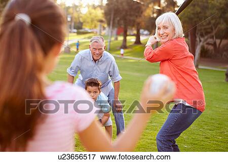 Stock Photo - Grandparents Playing Baseball With Grandchildren In Park. Fotosearch