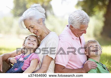Stock Image - Grandparents with grandchildren in the country. Fotosearch