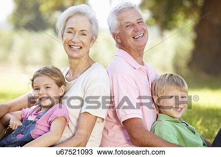 Stock Image - Grandparents with grandchildren in the country. Fotosearch