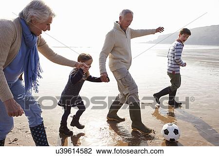 Grandparents With Grandchildren Playing Football On Beach View Large Photo Image Stock Image - Grandparents With Grandchildren Playing Football On Beach. Fotosearch